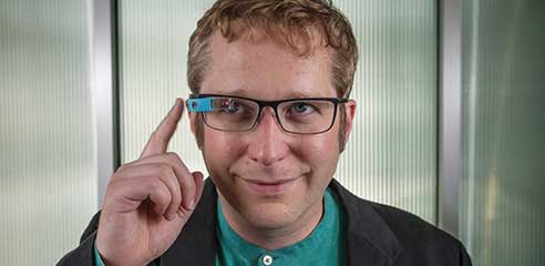 A man wearing a computing device on his glasses